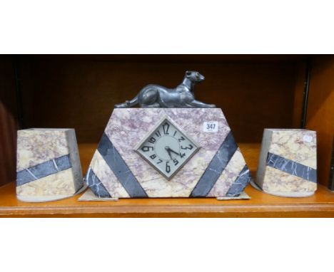 A French coloured marble mantel clock with leopard mount and a pair of matching side vases  
