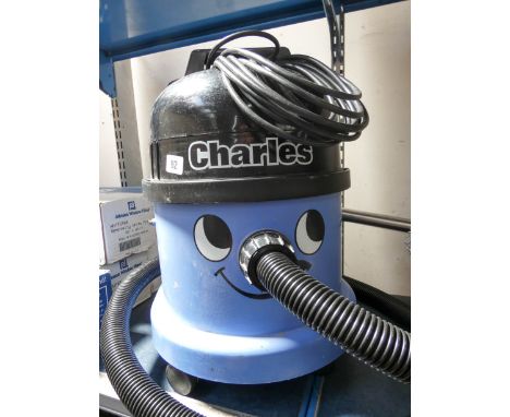 A blue Charles Henry style hoover with tools 