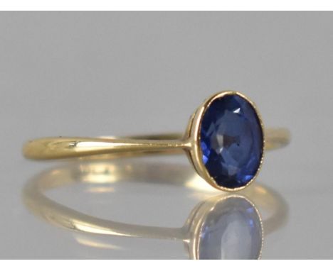 A Late 19th/Early 20th Century Sapphire and 18ct Gold Solitaire Ring, Oval Cut Sapphire Measuring 6mm by 4.5mm, Bezel Set to 