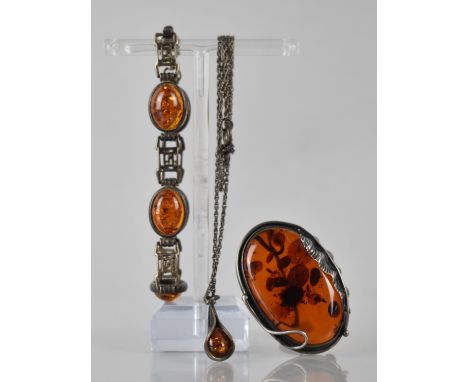 Three Silver Mounted Amber Items to include Panelled Bracelet comprising Five Oval Amber Cabochons, Brooch with Stylised Leaf