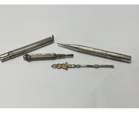 Two silver pencils and a silver pencil case, and one other silver item.