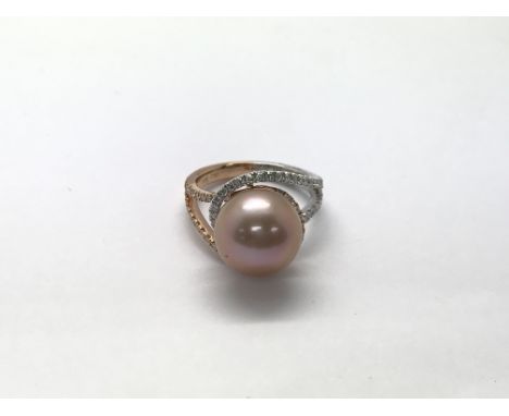 An 18ct rose gold and white gold two tone ring set with a large pink pearl and diamonds, approximately 0.49ct. The ring size 