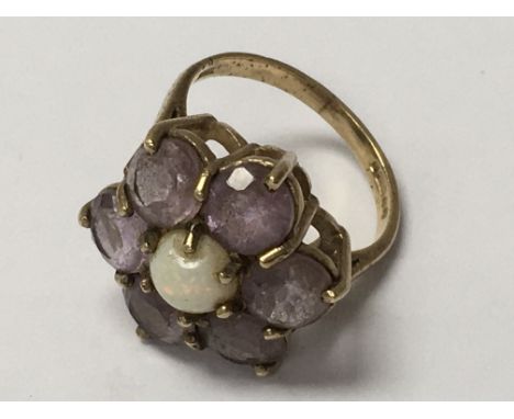 A 9ct gold ring inset with amethyst stones and opal, in the form of a flower. Ring size K - NO RESERVE