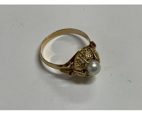 A high ct gold ( tested) ring set with a Pearl. L.