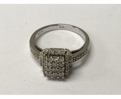 A 9carat white gold ring set with a stepped rectangular pattern of brilliant cut diamonds. Ring size J.