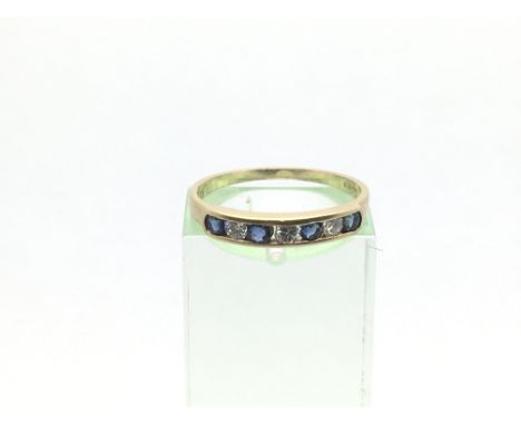 An 18ct gold ring set with three diamonds and four sapphires, approx 1.7g and approx size M.