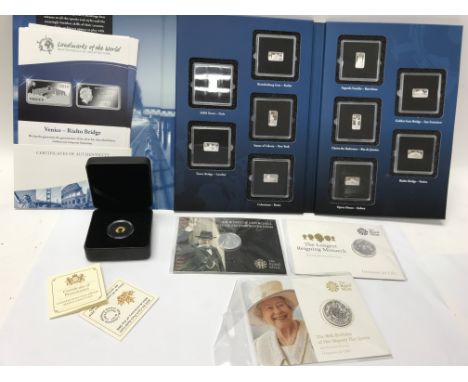 A Canadian Maple Leaf gold proof coin, a silver ingot set displaying landmarks of the world, and three other mint silver coin