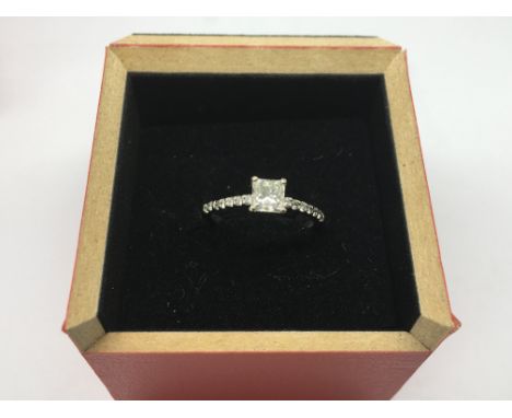 An 18ct white gold ring set with a princess cut diamond, approx 0.70pts with further diamonds, approx 2.2g and approx size L,