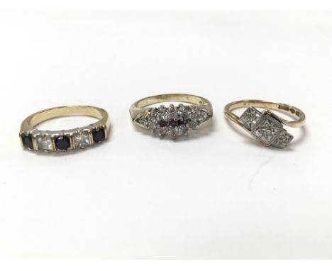 A collection of three rings - one gold ring set with three small chip diamonds (measuring approximately size m) and two yello