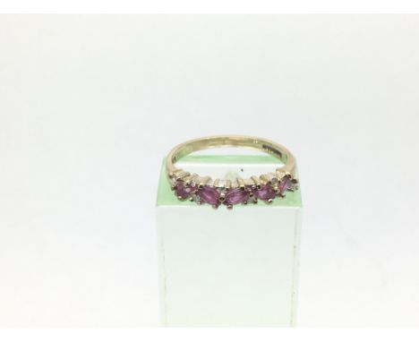 A 9ct gold ring set with dive rubies and six small diamonds, approx 1.7g and approx size K.