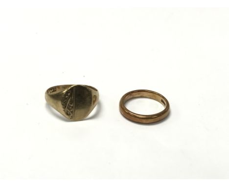 Two gold rings - one is a 22ct gold wedding band, measuring approximately between J and K, and weighing approximately 4.9g. T