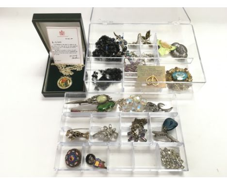 A boxed silver coin pendant and a case of costume jewellery (2).