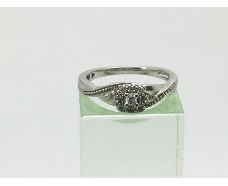 A silver diamond cluster ring, approx 0.12ct, approx size M.