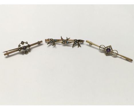Three Edwardian brooches. One 15ct gold brooch set with seed pearl and amethyst, one 9ct gold brooch set with seed pearl and 