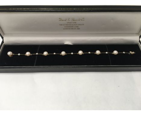 An elegant 9 carat diamond and Pearl line bracelet.