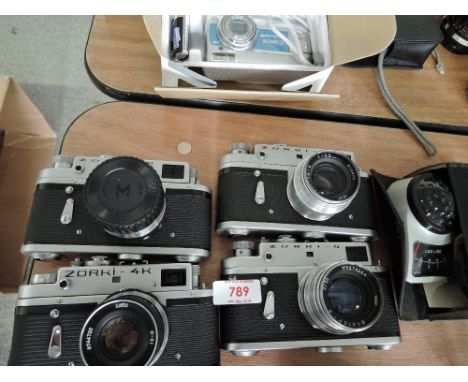 Three Zorki-4 cameras, a Zorki -4K and a Weston light meter
