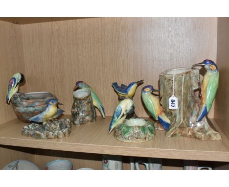 SIX PIECES OF RADFORD POTTERY MOUNTED WITH BIRDS, comprising a vase in the form of a tree trunk mounted with a pair of woodpe