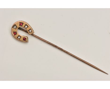 A YELLOW METAL GEM SET, HORSESHOE STICK PIN, set with three circular cut rubies and three rose cut diamonds (one stone is mis
