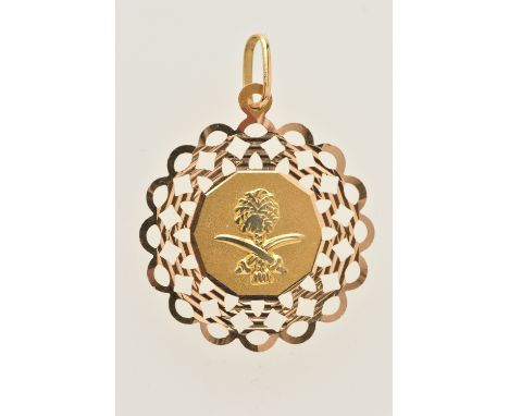 A YELLOW METAL MIDDLE EASTERN PENDANT, depicting a palm tree and crossed daggers, to the open work scalloped surround, stampe