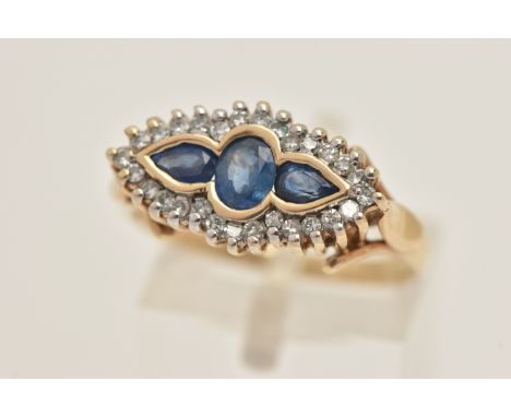 A 9CT GOLD SAPPHIRE AND DIAMOND RING, of a lozenge shape, set with a central oval cut sapphire flanked with pear cut sapphire