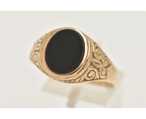 A GENTS 9CT GOLD ONYX SIGNET RING, of an oval form, set with a polished onyx inlay, collet set to the scrolling shoulders and