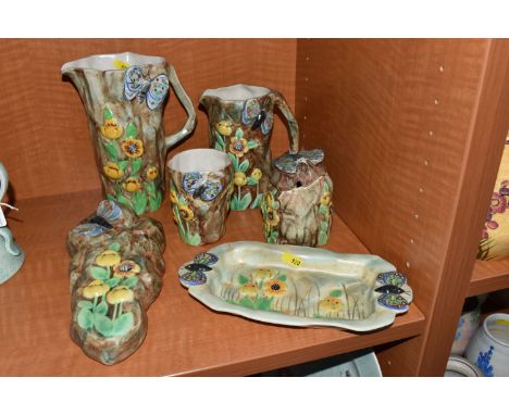 A GROUP OF RADFORD POTTERY 'BUTTERFLY WARE',  c1939, comprising a wall pocket, two jugs (smaller jug has a hairline crack fro