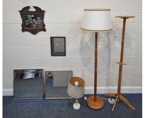 A REPRODUCTION WALL MIRROR, with a broken arch pediment, 47cm x 54cm, four other wall mirrors, a table lamp, a standard lamp,