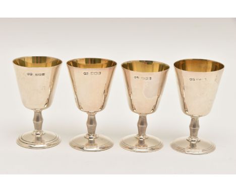 A SET OF FOUR SILVER MINIATURE GOBLETS, polished cups with vibrant gilt interiors, tapered stems on round weighted bases, eac