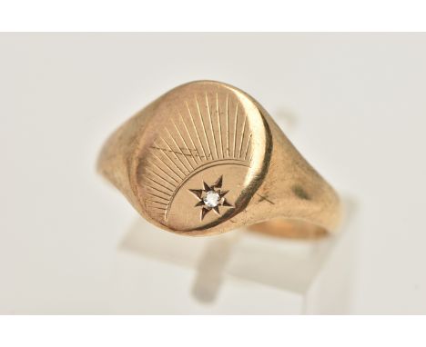 A GENTS 9CT GOLD SIGNET RING, of an oval form, sunburst detail with a star set single cut diamond, to a polished band, hallma