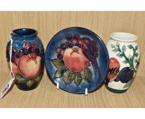 THREE MOORCROFT POTTERY BY SALLY TUFFIN ITEMS comprising a small 'Plum with a Resting Bird' patterned vase, height 10.5cm, an