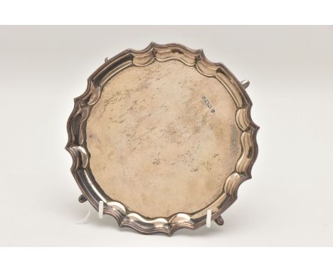 A SILVER WAITER, circular form with wavy rim, raised on three hoof feet, hallmarked 'Francis Howard Ltd' Birmingham 1975, app