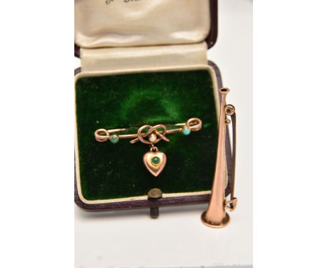 TWO LATE VICTORIAN BROOCHES, the first a yellow metal bar brooch with a lovers knot and a heart dropper, set with three caboc
