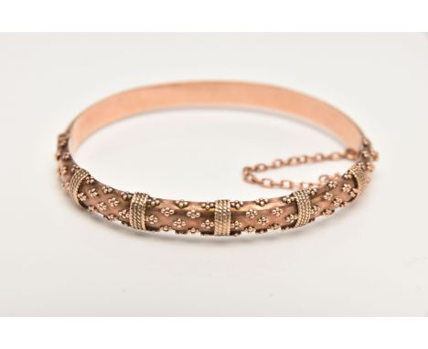 A 9CT ROSE GOLD HINGED BANGLE, decorated with bead work, fitted with a push button clasp and additional safety chain, hallmar