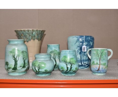 A GROUP OF SEVEN RADFORD VASES OF VARIOUS FORMS comprising a group of four vases with hand-painted tree scenes on a green-blu