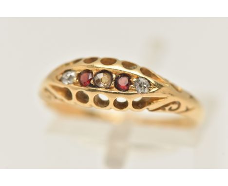AN 18CT GOLD RUBY AND DIAMOND BOAT RING, set with old cut diamonds interspaced with two circular cut garnets, scrolling shoul