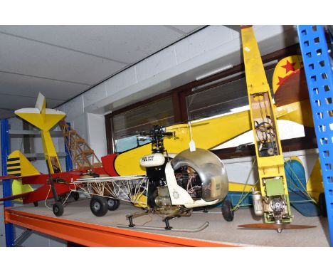 A GROUP OF VINTAGE REMOTE CONTROLLED PLANES AND PARTS comprising eight plane chassis, some with petrol engines, a Morley poli