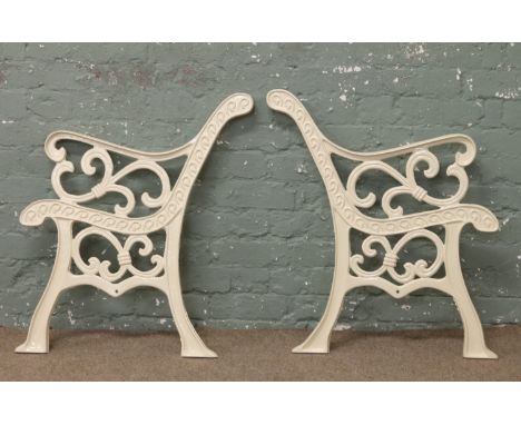 A pair of painted cast iron bench ends.