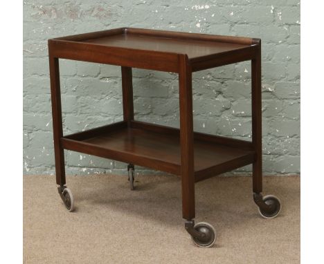 A vintage mahogany two tier tea trolley purportedly from the Royal ordnance factory in Ranskill, stamped and stencilled to th