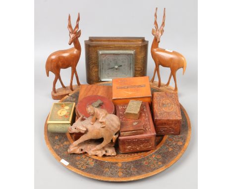 A group of mostly decorative wooden items including oriental carvings of figures on water buffalo trinket boxes, charger etc.