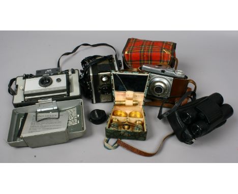 A Polaroid land camera automatic 103 along with a Digna Kamerawerk camera made in Germany and a coronet twelve-2- camera with