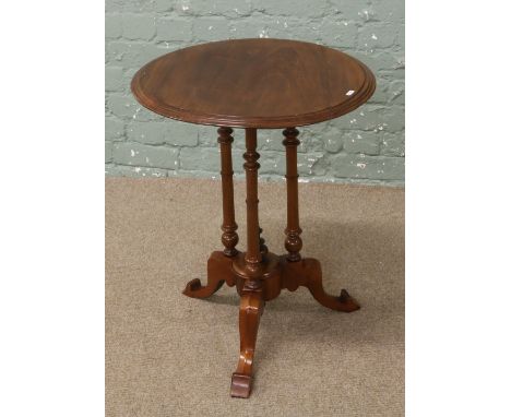 A walnut occasional table raised on tripod base with centre finial.