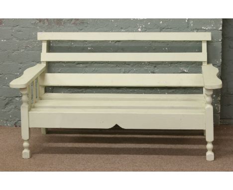 A painted green wooden garden bench.