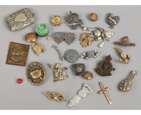 A silver jubilee tin and contents of military badges, silver A.R.P Royal Army medical corps and a WWII wound badge etc.