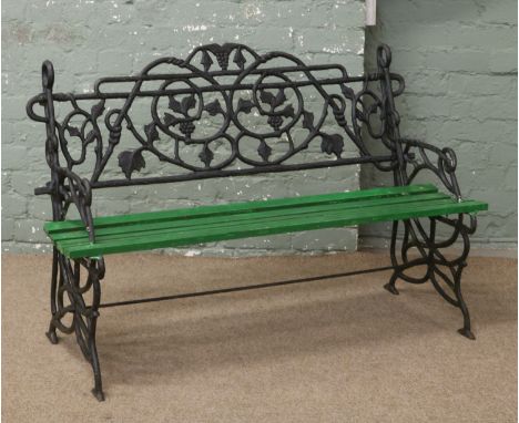 A Coalbrookdale style iron work bench with vinework back rest.