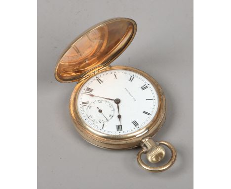 A vintage gold plated presentation full hunter pocket watch with white enamel dial and subsidiary seconds.