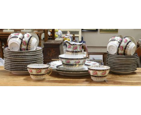 A china tea service decorated with roses, blue borders and gilding, 37 pieces.