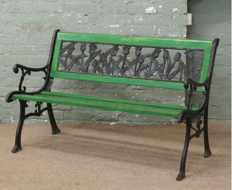 An iron and painted wooden garden bench the backrest formed as tulips.