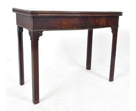 A 19th century Victorian mahogany card / games table. The table having a serpentine fold over table with deep frieze below. A