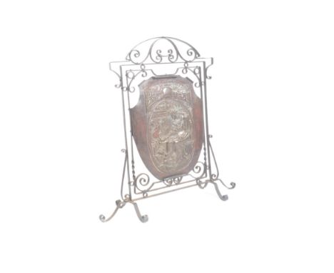 A late 19th century Victorian Arts &amp; Crafts copper embossed fire screen panel held within a wrought iron support scrolled