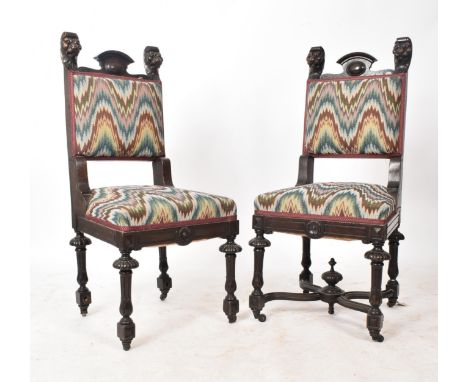 A pair of Victorian 19th century oak Gothic revival Carolean dining chairs. Each chair having a shaped gallery back flanked b